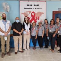 MSF doctors, wearing white vests, visit with Pascual and the Siempre Unidos staff