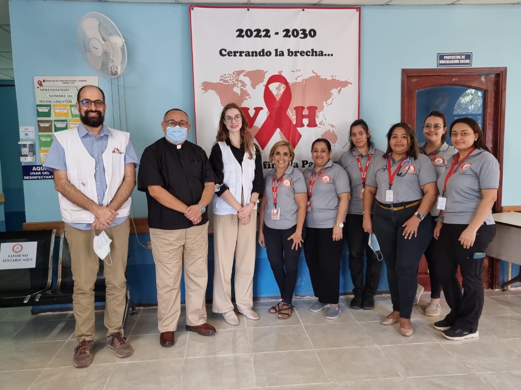 MSF doctors, wearing white vests, visit with Pascual and the Siempre Unidos staff